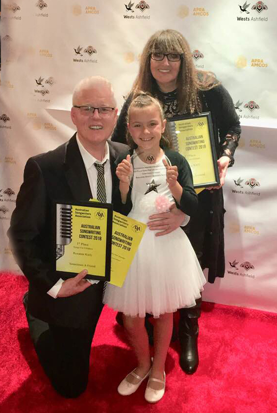 Roxanne celebrates her co-writing award for 1st Place in the songs For Children at the Australian Songwriters Association 2018 Awards night with co-writer Stephen Kiely, pictured here with the dynamic young performer Sky Clementine, who sang the winning song, Sometimes A Friend